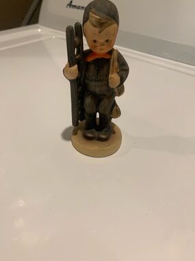 Vintage-Style Brown and Cream Ceramic Boy Figurine with Orange Bow